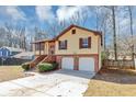 Charming split-level home with a two-car garage, brick accents, and landscaped front yard at 5508 Hadrian Ct, Lithonia, GA 30058