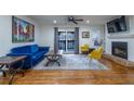 Open-concept living room with fireplace, hardwood floors, natural light, and stylish decor at 1901 Cumberland Ct, Smyrna, GA 30080