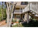 View of the exterior featuring decks and mature landscaping at 2135 N Forest Trl, Dunwoody, GA 30338