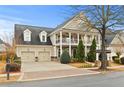 Charming two-story home with a welcoming front porch, manicured landscaping, and a two-car garage at 654 Crystal Cove Ct, Loganville, GA 30052