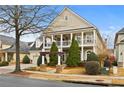 Two-story home featuring a charming front porch, manicured landscaping, and attached garage at 654 Crystal Cove Ct, Loganville, GA 30052
