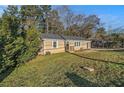 Cozy one-story home with a green lawn, complemented by mature trees at 1997 Columbia Dr, Decatur, GA 30032