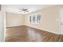 Spacious living room featuring wood-look flooring, ceiling fan and multiple windows at 1997 Columbia Dr, Decatur, GA 30032