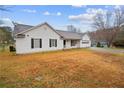 Side view of a quaint single-story home, featuring white siding and an expansive front yard at 331 Cobblestone Rd, Auburn, GA 30011