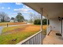 Inviting front porch view of the home with a spacious front yard and street view at 331 Cobblestone Rd, Auburn, GA 30011