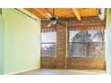 Bedroom featuring exposed brick wall and ceiling beams, and ample natural light at 204 Walker Sw St # 208, Atlanta, GA 30313