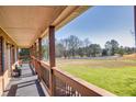 Covered porch overlooking a sprawling yard, providing a serene outdoor space at 5692 Rock Patch Rd, Loganville, GA 30052