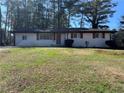 Single-story home with a well-manicured lawn and a cozy, inviting facade at 4025 Gretna Green Dr, Decatur, GA 30035