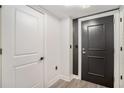 Modern entryway featuring gray vinyl flooring and a black front door with modern hardware at 200 River Vista Dr # 608, Atlanta, GA 30339