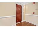 Hallway with a stained wood door with a brass number and a staircase sign at 200 River Vista Dr # 608, Atlanta, GA 30339