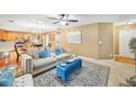 Cozy living room featuring a comfortable sofa, neutral walls, and an open view to the kitchen area at 7595 Waverly Loop, Fairburn, GA 30213
