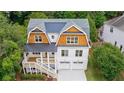 Aerial view of a two-story home with cedar shake roof, lush greenery, and a charming front porch at 2717 Skyland Dr, Brookhaven, GA 30319