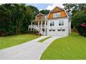 Beautiful home with lush green front lawn, complemented by a long concrete driveway at 2717 Skyland Dr, Brookhaven, GA 30319