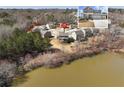 Aerial view of a gray home near a tranquil lake, providing a serene and picturesque setting at 6145 Stargazer Way, Cumming, GA 30028