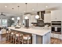 A spacious kitchen boasts modern finishes, pendant lighting, and an expansive island at 1047 Brandsford Nw St, Atlanta, GA 30318