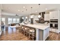 Bright, open kitchen featuring a large island, stainless steel appliances and hardwood floors at 1047 Brandsford Nw St, Atlanta, GA 30318