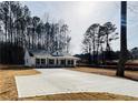 New construction home featuring a modern color scheme and long concrete driveway at 488 West Ave, Bowdon, GA 30108