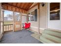 Cozy screened porch with a red chair, carpet, and views of the outdoors at 718 Old Tennessee Ne Hwy, White, GA 30184