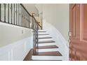 Inviting foyer with elegant staircase featuring iron railing and hardwood steps, plus beautiful trim work at 826 Bexley Park Way, Mableton, GA 30126