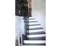 Elegant staircase with dark wood railings and white trim, creating a classic and sophisticated look at 826 Bexley Park Way, Mableton, GA 30126