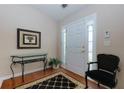 Inviting foyer with hardwood floors, decorative console table, and elegant decor at 4030 Crescent Walk Ne Ln, Suwanee, GA 30024