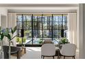 Bright living room with floor-to-ceiling windows overlooking a pool with an inflatable swan at 4380 Garmon Nw Rd, Atlanta, GA 30327