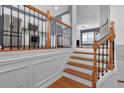 Elegant staircase with decorative iron railing leading to an open-concept kitchen and living area at 4874 Seldon Se Way, Smyrna, GA 30080