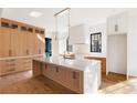Spacious kitchen features custom cabinets, marble countertops, and modern appliances, creating an inviting culinary space at 555 Orme Ne Cir, Atlanta, GA 30306