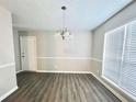 Well lit dining room with new floors and a classic chandelier at 738 Windsor Cir, Lawrenceville, GA 30046