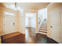 Warm foyer featuring hardwood flooring, staircase leading upstairs, and a bright and airy ambiance at 1092 Park Hollow Ln, Lawrenceville, GA 30043