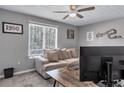 This bedroom features a cozy couch, large window, and a ceiling fan for optimal comfort at 5545 Circlestone Ln, Stone Mountain, GA 30083