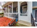 Inviting front porch entrance with hanging plants and decorative railings at 1341 Inman Ct, Norcross, GA 30093
