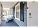 Cozy screened front porch featuring a secure keypad entry and modern lighting at 1341 Inman Ct, Norcross, GA 30093