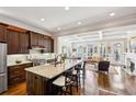 Spacious kitchen featuring an island with seating, modern appliances and hardwood floors at 194 Inman Ne Ln, Atlanta, GA 30307