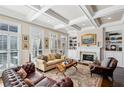 Inviting living room featuring coffered ceilings, a fireplace, built-in shelving, and ample natural light at 194 Inman Ne Ln, Atlanta, GA 30307
