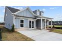 Side view of a single-Gathering home featuring light blue siding, a paved drive, and well-kept lawn at 3543 Cedarvale Ct, Powder Springs, GA 30127