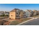 Lovely home with stone and neutral siding, manicured lawn, and neighborhood view at 4440 Croftshire Pl, Cumming, GA 30040