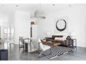Inviting living room with a unique lighting fixture, contemporary art, and polished concrete floors at 455 Glen Iris Ne Dr # D, Atlanta, GA 30308