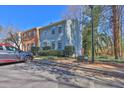 Two-story townhouse featuring siding, multiple windows, and parking at 1050 Wedgewood Ln, Tucker, GA 30084