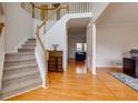 Bright foyer showcasing hardwood floors, staircase and an elegant console table at 1413 Eastbrooke Way, Marietta, GA 30066