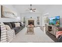 Inviting living room with stone fireplace, vaulted ceilings, and abundant natural light at 88 Summer Lake Pl, Dallas, GA 30157