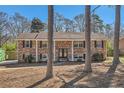 Charming brick home featuring classic shutters and a well-maintained yard at 3045 Riviera Nw Dr, Conyers, GA 30012