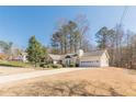 Charming single Gathering home boasting manicured landscaping and a two-car garage at 7238 Hummingbird Ln, Winston, GA 30187