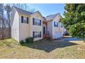 Charming two-story home featuring a well-maintained yard and a two-car garage at 375 Tambec Nw Trce, Lilburn, GA 30047