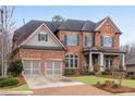 Charming brick home with a manicured front yard and attached garage at 4850 Kentwood Dr, Marietta, GA 30068