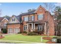 Beautiful brick home featuring a cozy front porch and landscaped yard at 4850 Kentwood Dr, Marietta, GA 30068