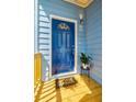 A vibrant blue front door complemented by a decorative pot and a welcoming 'HOME' doormat at 813 Smith Sw St # B, Atlanta, GA 30310
