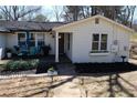 Welcoming home with a cozy front porch and beautifully landscaped garden at 2184 E Cherokee Dr, Woodstock, GA 30188
