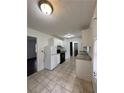 Well-lit kitchen features white cabinets, granite countertops, tile flooring, and modern appliances at 2717 Rosemont Dr, Lawrenceville, GA 30044