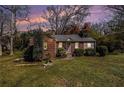 Cozy brick home exterior at dusk, showcasing its well-maintained lawn and landscaping at 3542 W Hill St, Clarkston, GA 30021